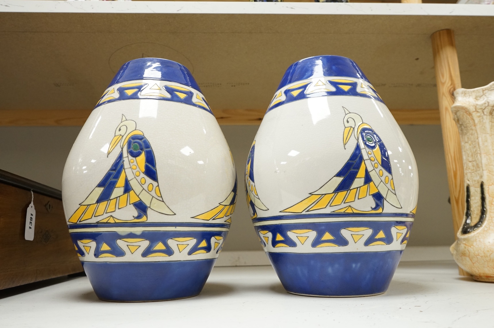 A pair of contemporary Boch Keramis pottery stylised Egyptian bird vases